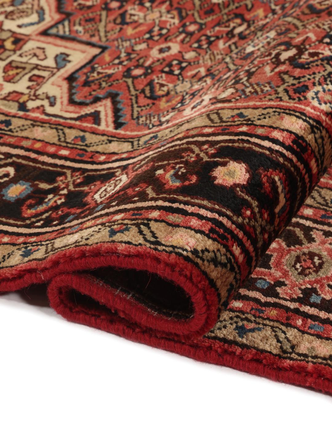Hand-knotted Hosseinabad rug from the Middle East in deep red and black