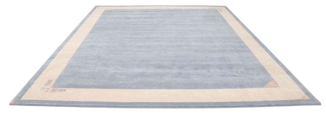 Handgeknoopt blauw wollen tapijt uit Nepal met een minimalistisch randontwerp
