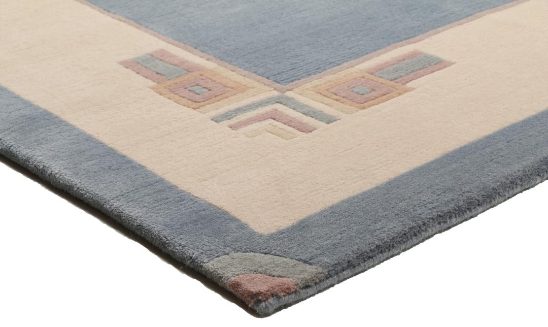 Handgeknoopt blauw wollen tapijt uit Nepal met een minimalistisch randontwerp