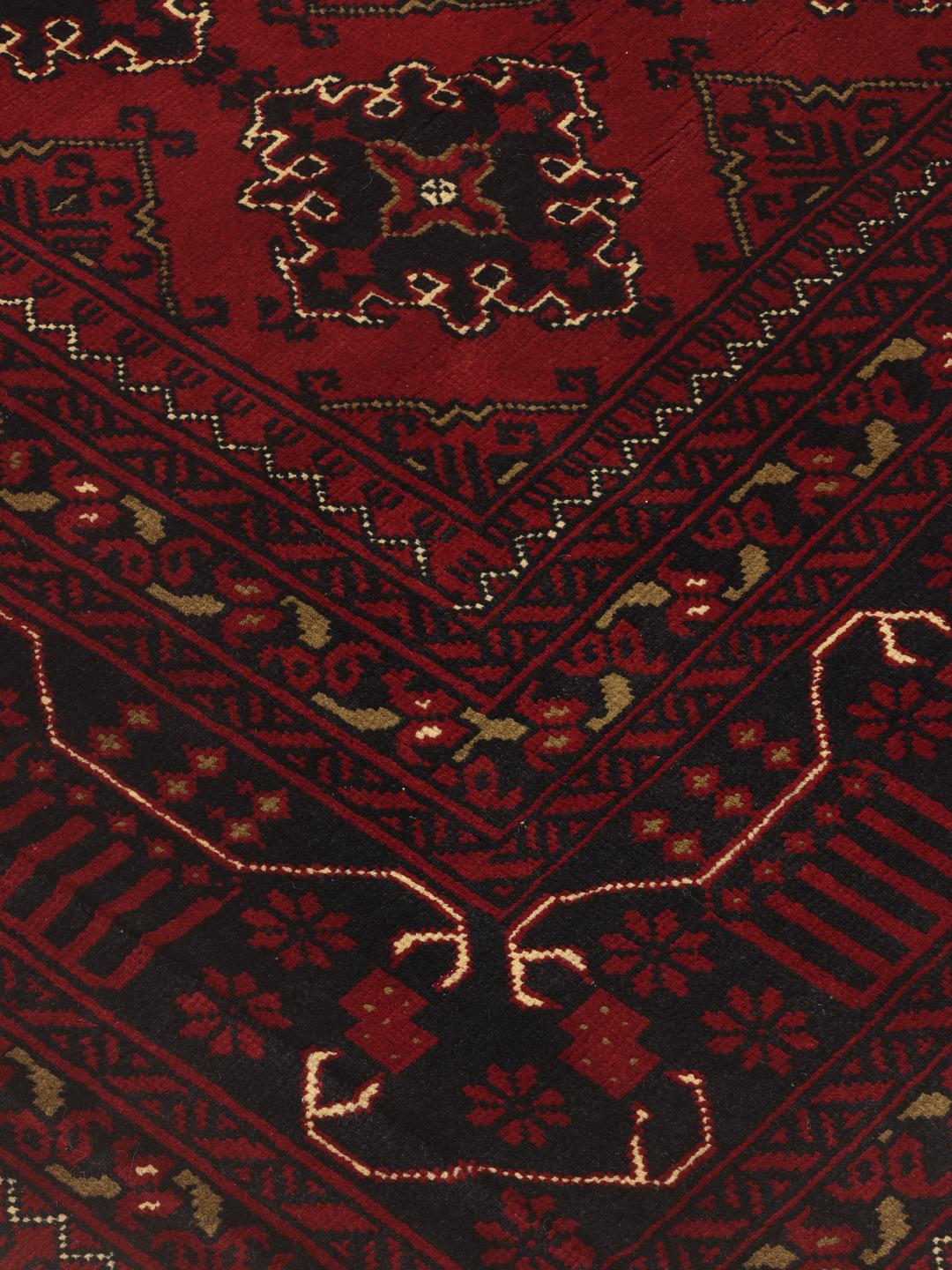 Hand-knotted Afghan Kunduz rug with red and black geometric patterns