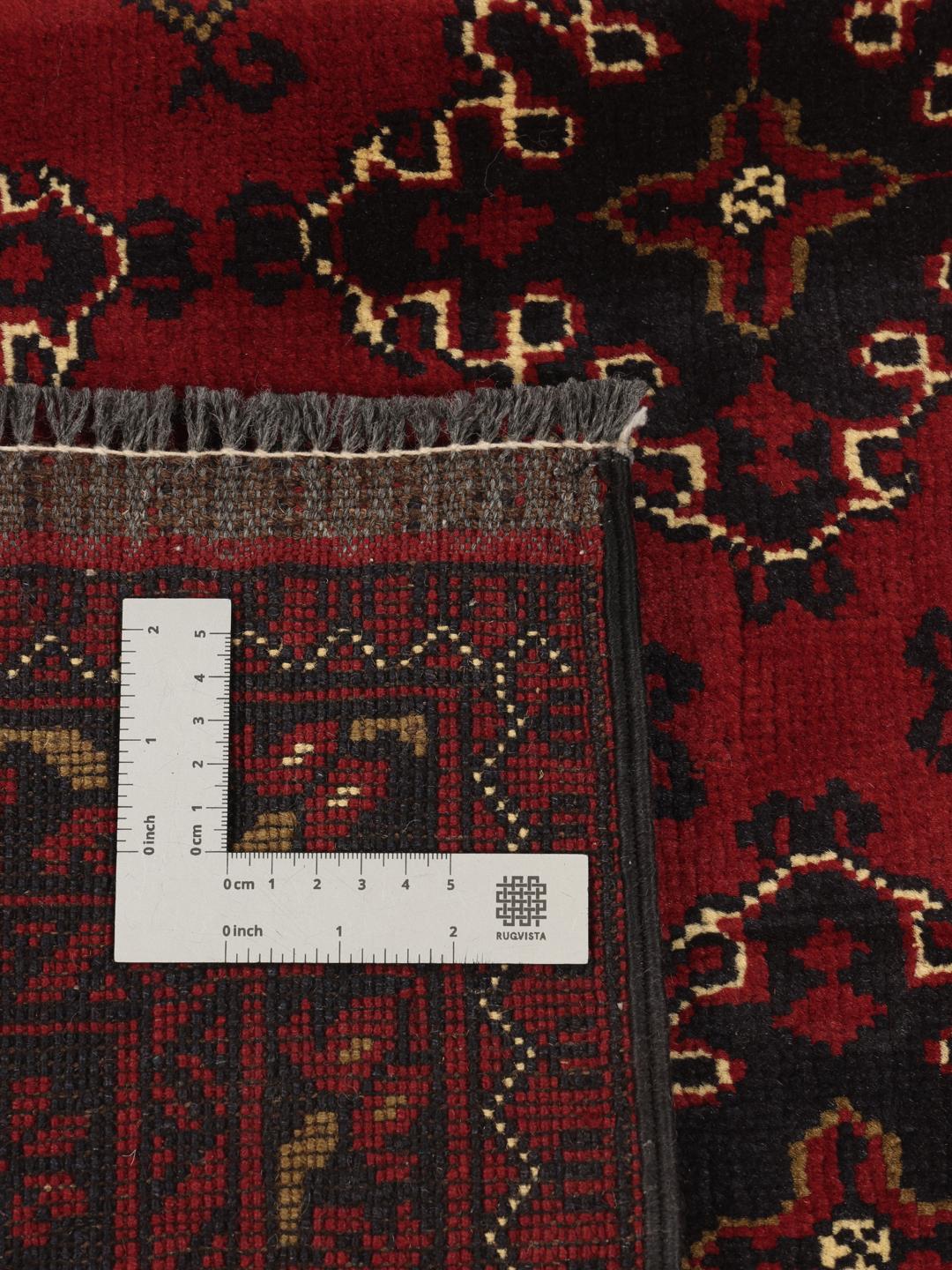 Hand-knotted Afghan Kunduz rug with red and black geometric patterns