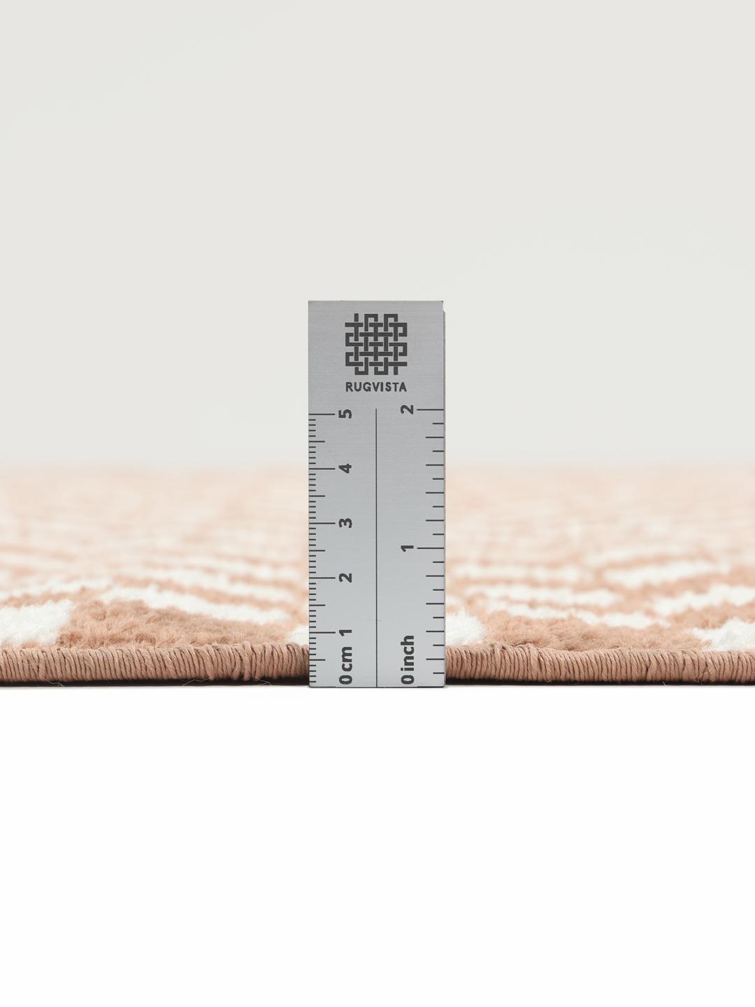 A rectangular rug with a terracotta and white checkerboard pattern.