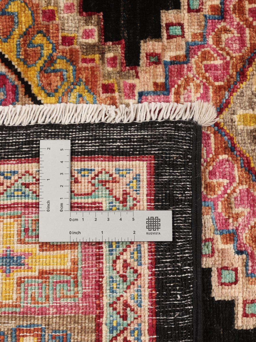 Hand-knotted Afghan rug with a black field and multicoloured diamond patterns.