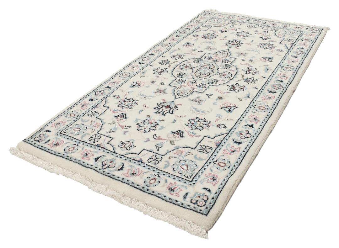 A hand-knotted Nain 9La rug from the Middle East in beige, blue, and pink colours.