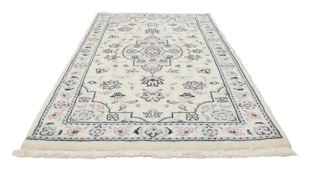 A hand-knotted Nain 9La rug from the Middle East in beige, blue, and pink colours.