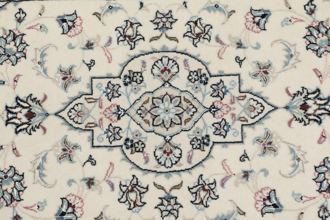 A hand-knotted Nain 9La rug from the Middle East in beige, blue, and pink colours.