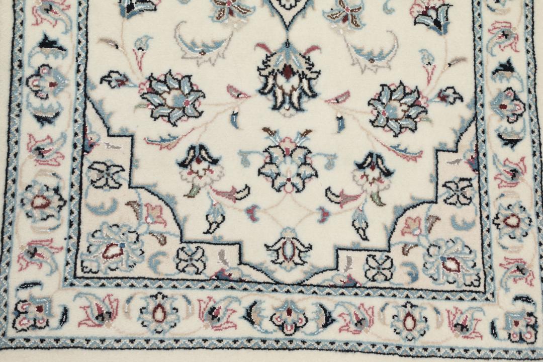 A hand-knotted Nain 9La rug from the Middle East in beige, blue, and pink colours.