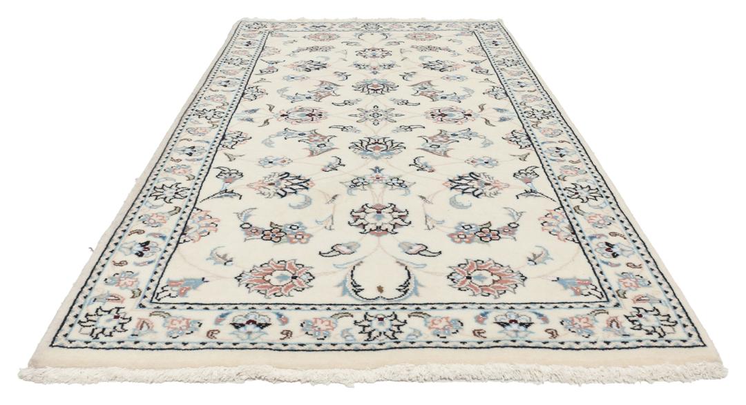 A hand-knotted Nain 9La rug from the Middle East featuring floral patterns in beige and soft blue.