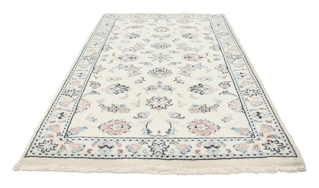 A hand-knotted Nain 9La rug from the Middle East featuring floral patterns in beige and soft blue.