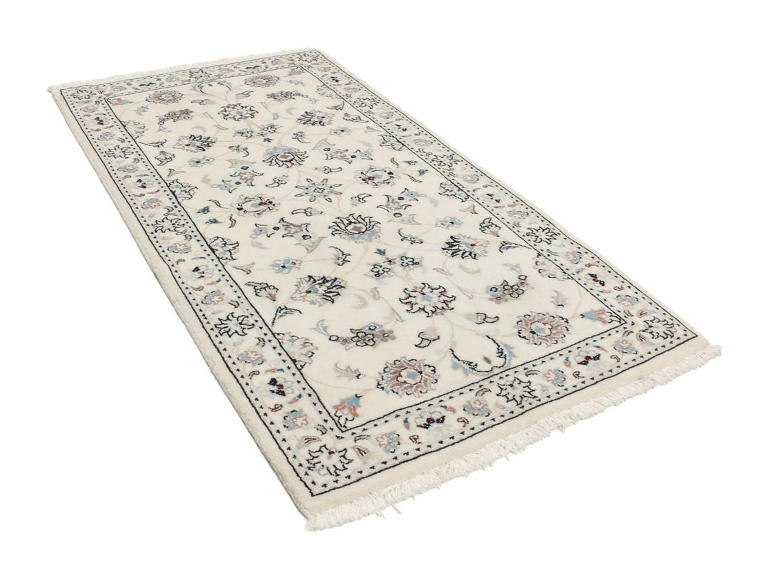 Een rechthoekig handgeknoopt Nain 9La tapijt met een beige veld en florale motieven uit het Midden-Oosten.