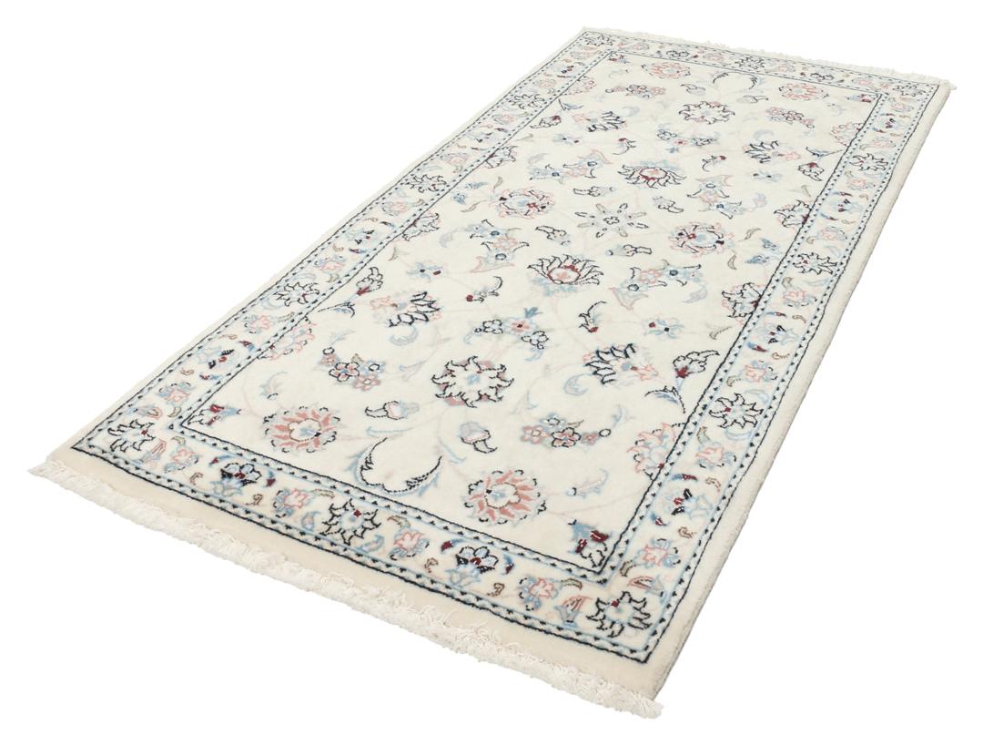 Hand knotted Nain 9La rug with delicate floral motifs on a cream background