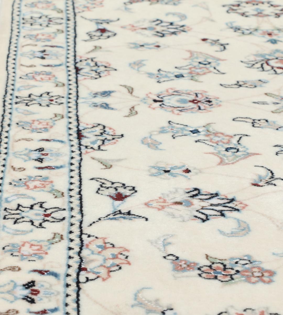 Hand knotted Nain 9La rug with delicate floral motifs on a cream background