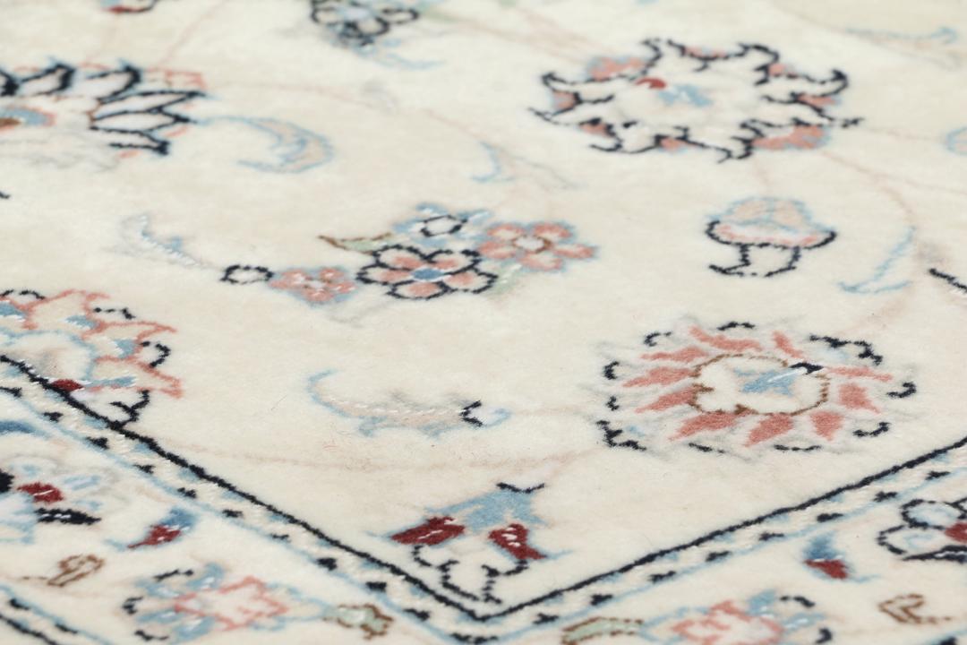 Hand knotted Nain 9La rug with delicate floral motifs on a cream background