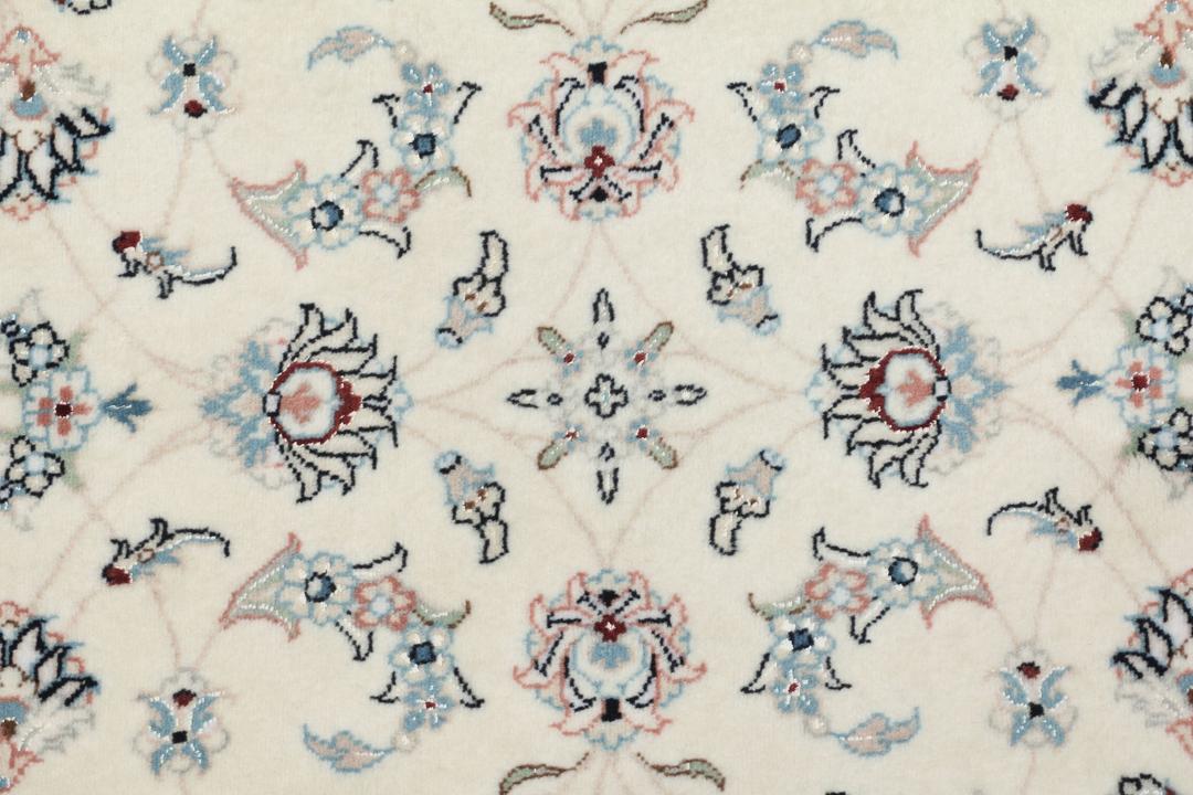 Hand knotted Nain 9La rug with delicate floral motifs on a cream background