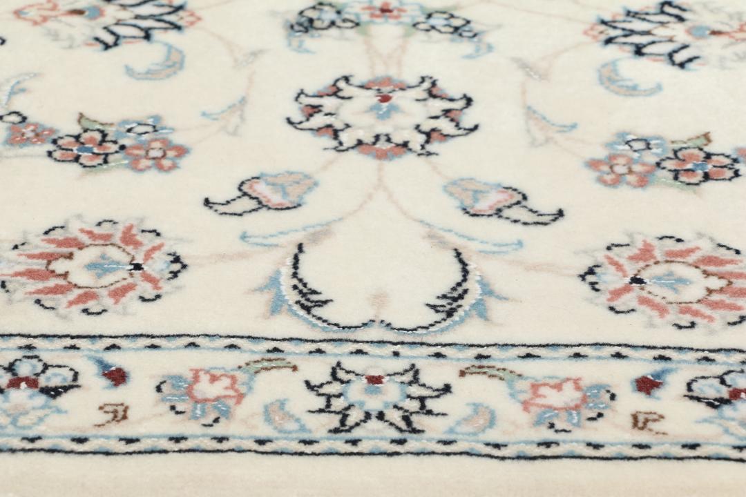 Hand knotted Nain 9La rug with delicate floral motifs on a cream background