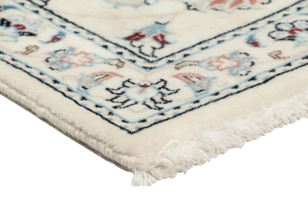 Hand knotted Nain 9La rug with delicate floral motifs on a cream background