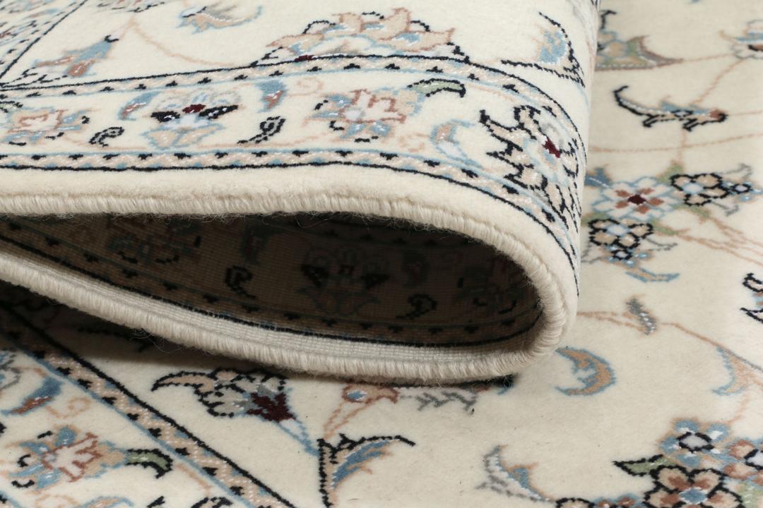 Hand knotted Nain 9La rug with delicate floral motifs on a cream background