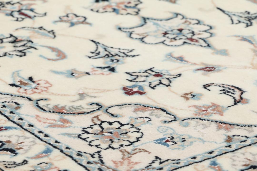 Hand-knotted Nain 9La rug from the Middle East in beige with intricate floral patterns
