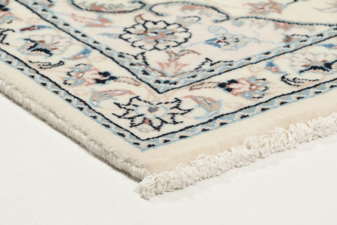 Hand-knotted Nain 9La rug from the Middle East in beige with intricate floral patterns
