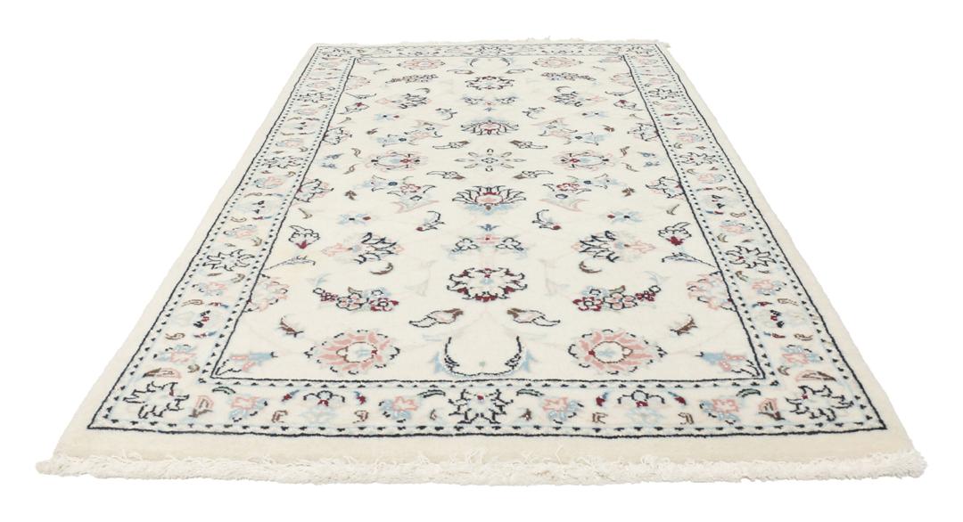 A rectangular Nain 9La rug from the Middle East with a beige background and floral motifs