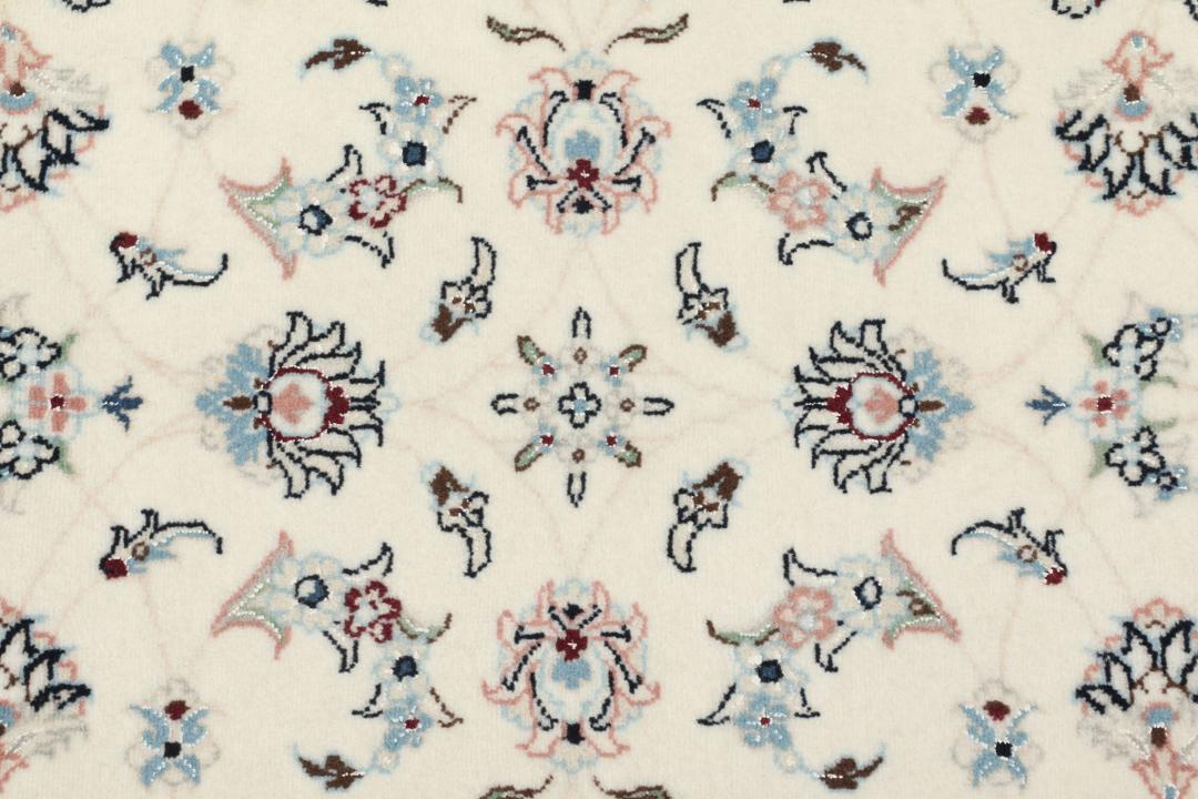 A rectangular Nain 9La rug from the Middle East with a beige background and floral motifs