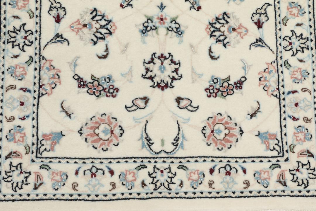 A rectangular Nain 9La rug from the Middle East with a beige background and floral motifs