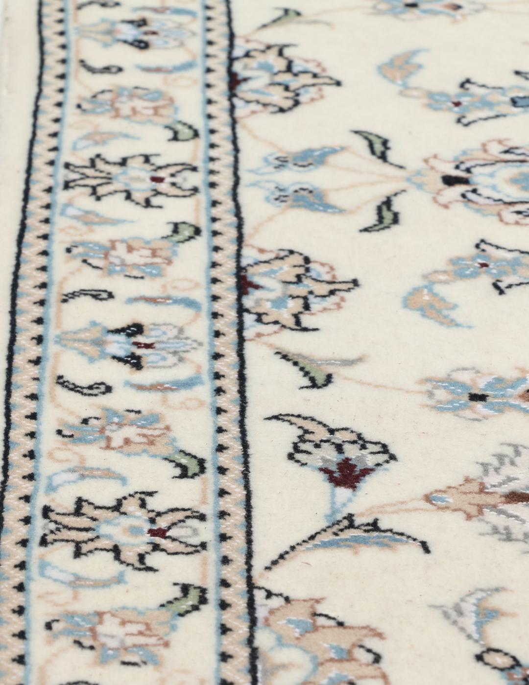 Handgeknoopt Nain 9La tapijt met delicate bloemmotieven op een beige achtergrond