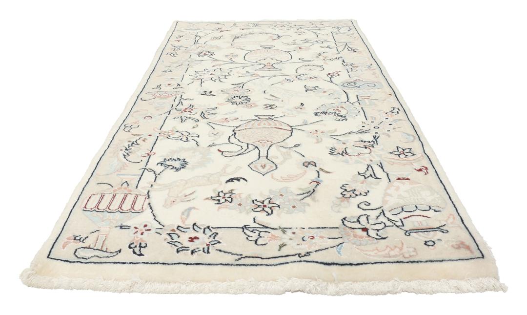 Et rektangulært håndknyttet Nain 9La-tæppe med delikate blomstermotiver i beige og blå nuancer.