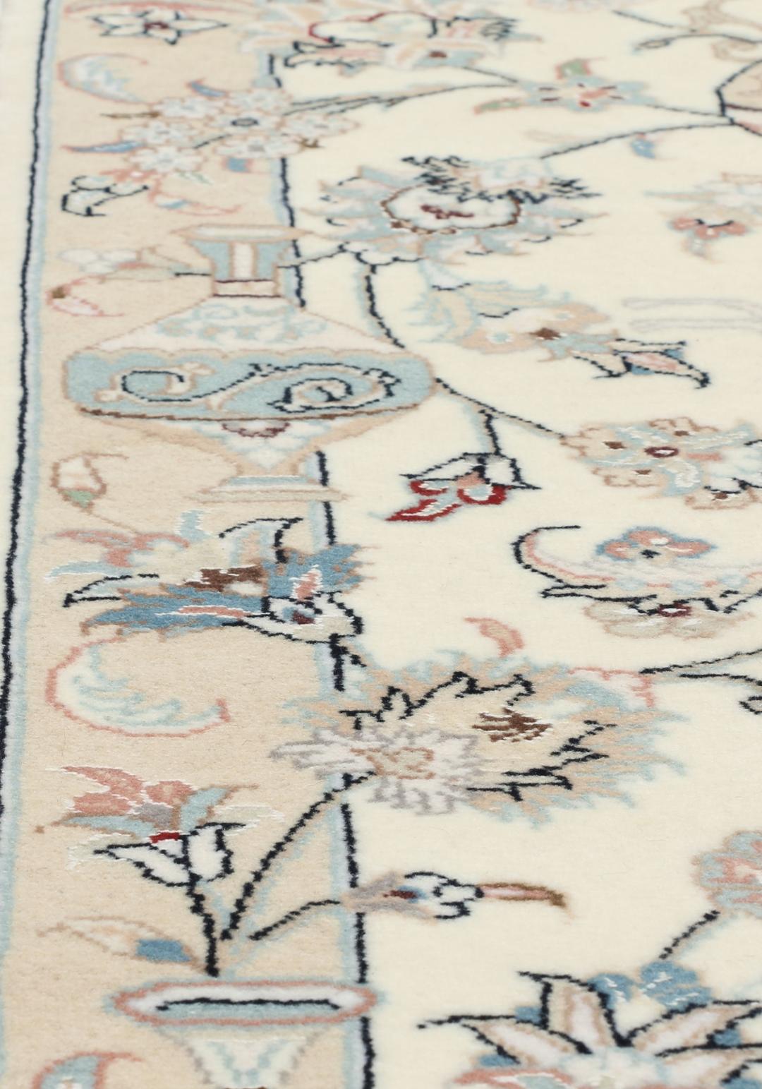 Hand-knotted Nain 9La rug from the Middle East in a soft beige colour with floral patterns