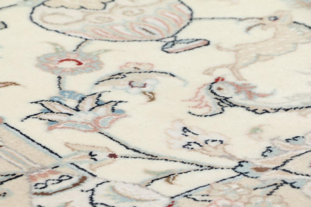 Hand-knotted Nain 9La rug from the Middle East in a soft beige colour with floral patterns