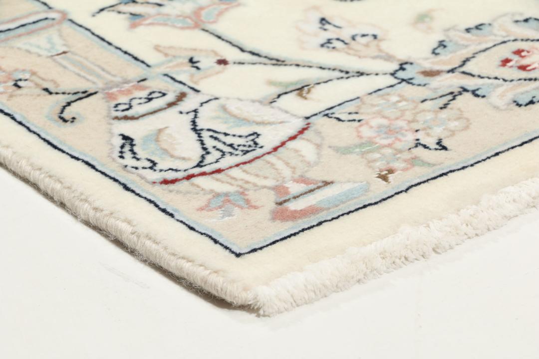 Hand-knotted Nain 9La rug from the Middle East in a soft beige colour with floral patterns