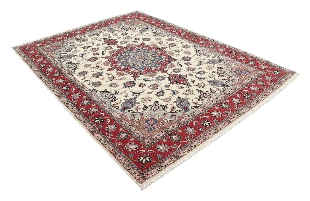 Un tapis Tabriz noué à la main provenant du Moyen-Orient avec un médaillon floral rouge sur fond crème.