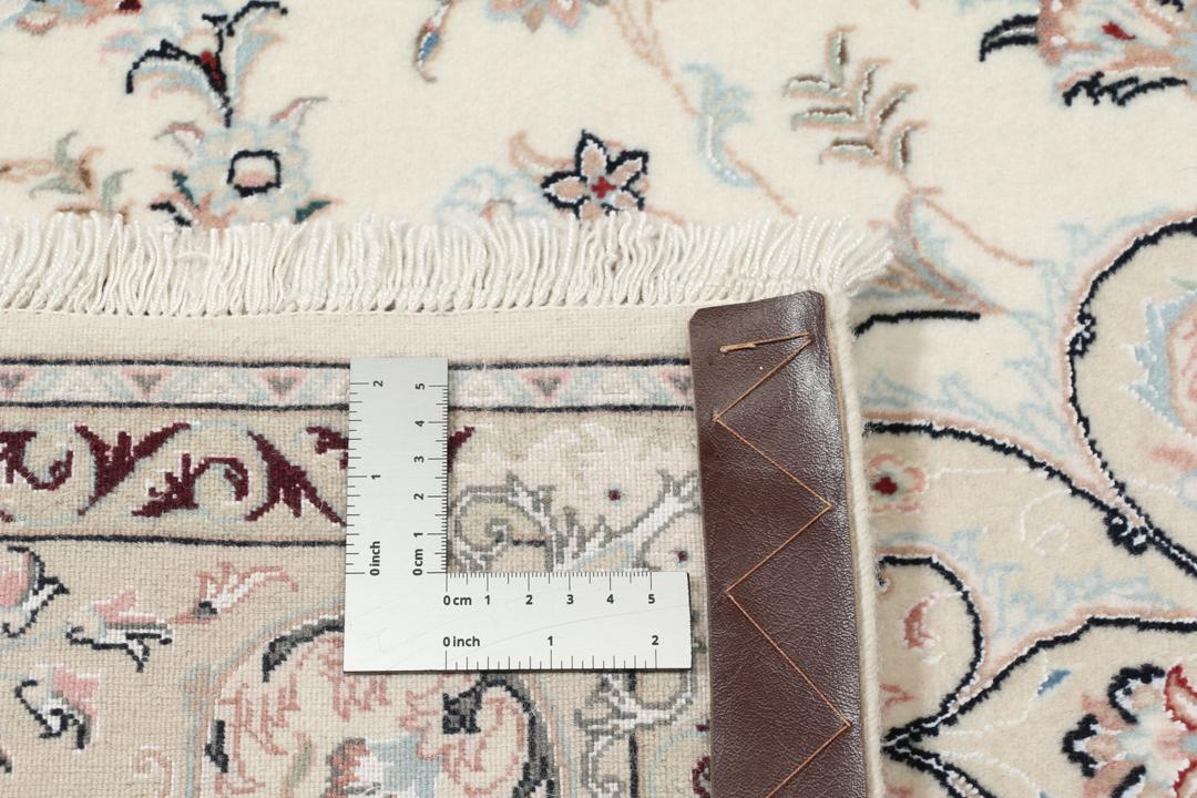 Et rektangulært håndknyttet Ilam Sherkat Farsh-tæppe med indviklede blomstermotiver i beige og bløde farver.