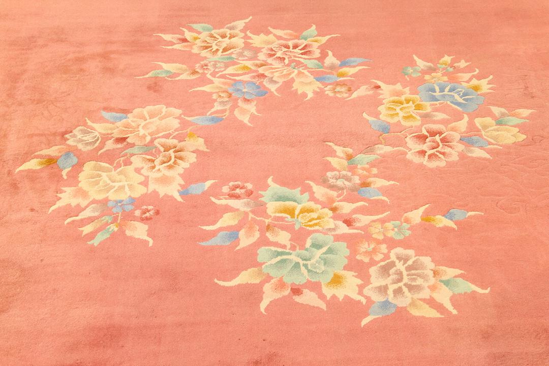 Antique Chinese Art Deco rug with floral motifs on a red background