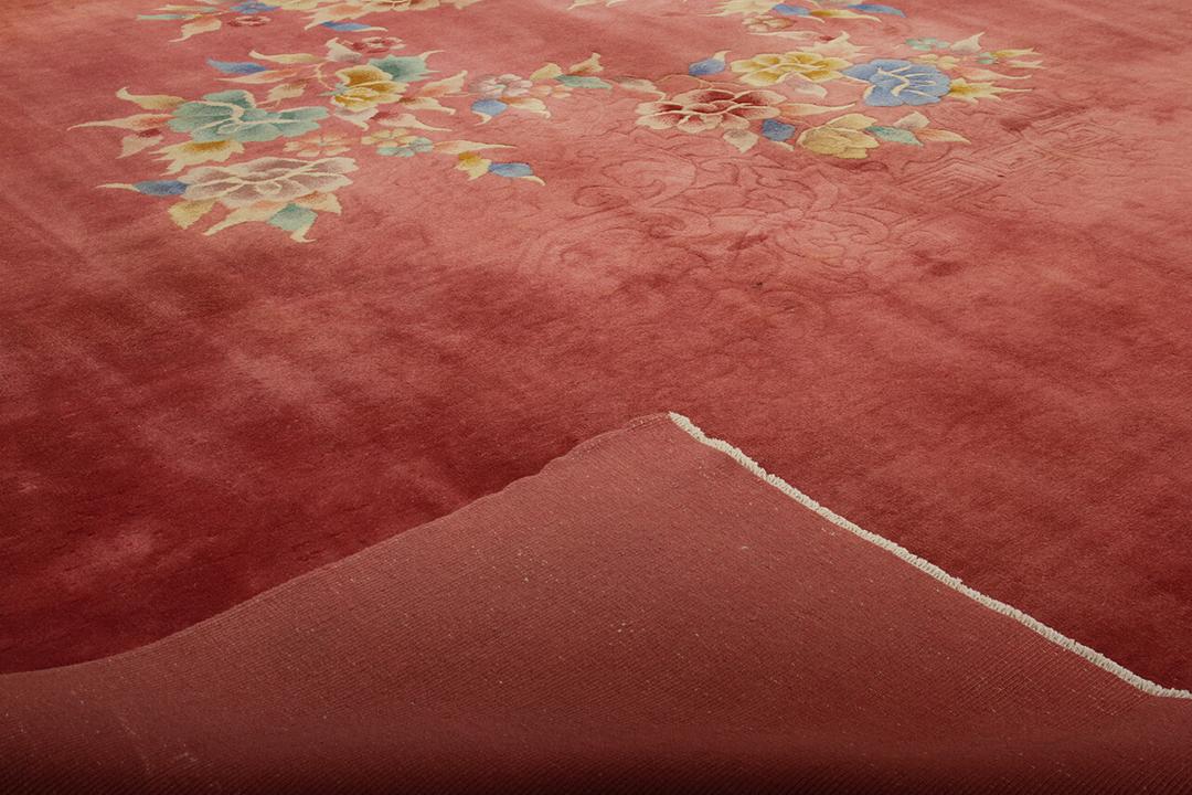 Antique Chinese Art Deco rug with floral motifs on a red background