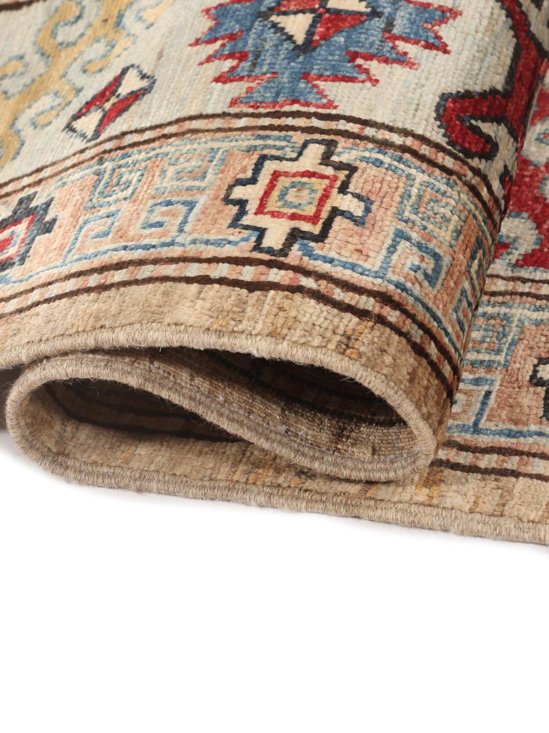 Hand-knotted Kazak rug from Afghanistan with a geometric pattern in beige, red, and blue