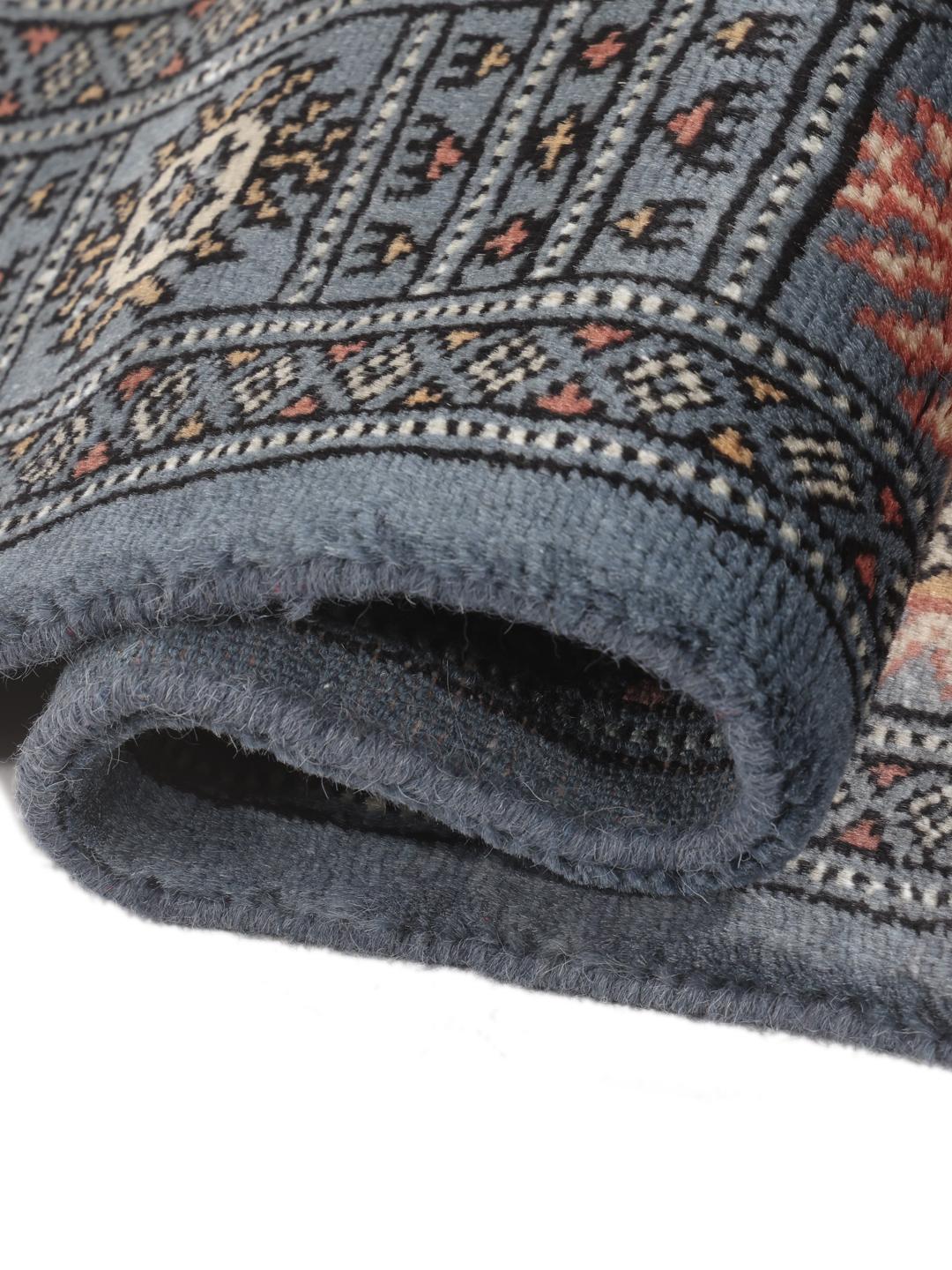 Hand-knotted blue Pakistan Bokhara rug with traditional medallion patterns