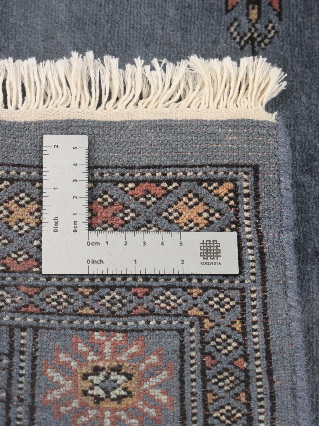 Hand-knotted blue Pakistan Bokhara rug with traditional medallion patterns