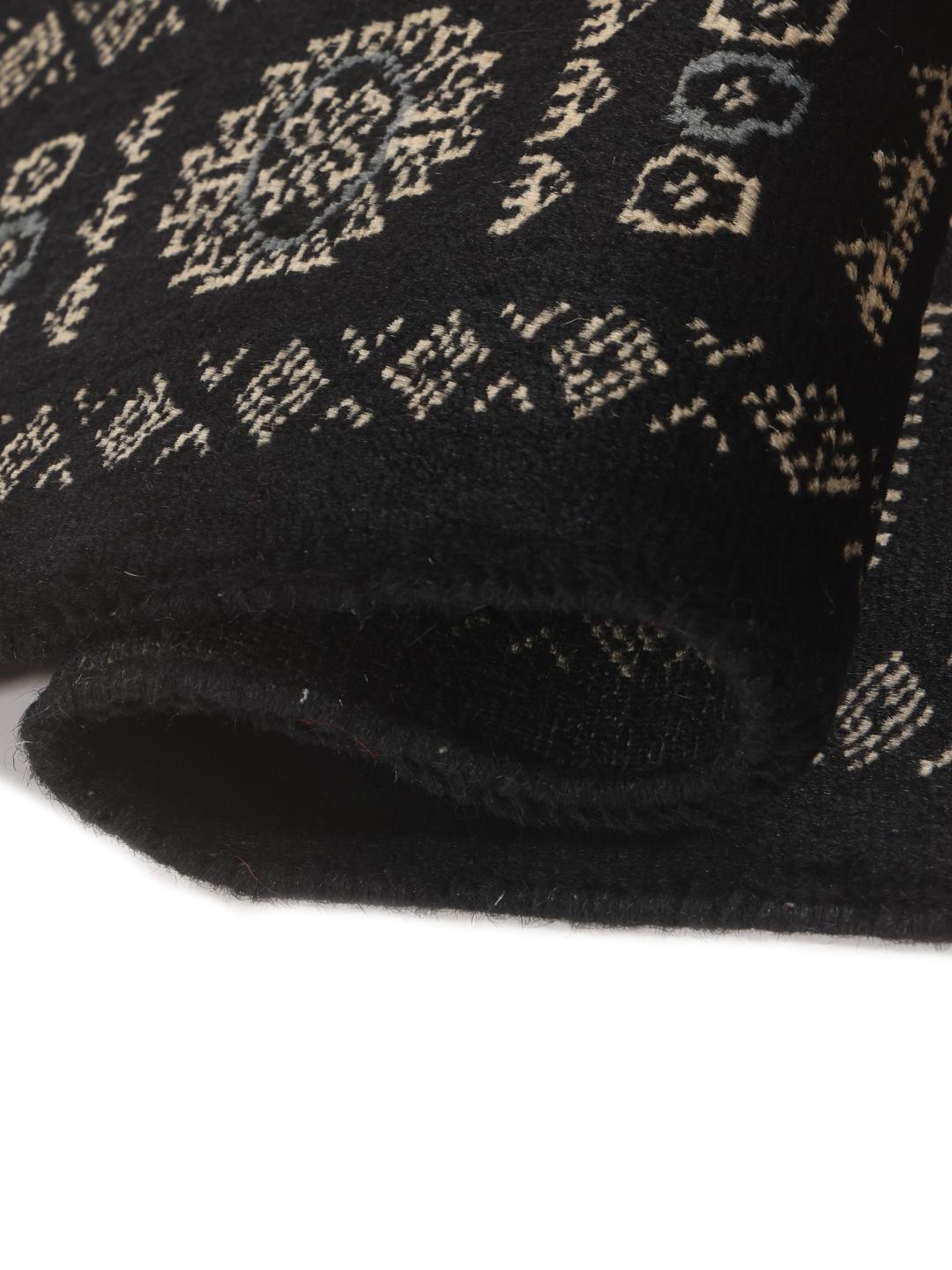 Hand-knotted Pakistan Bokhara rug in black with traditional geometric motifs
