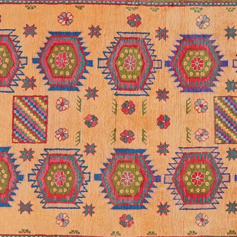 Antique Samarkand rug from China with a beige field and geometric medallions