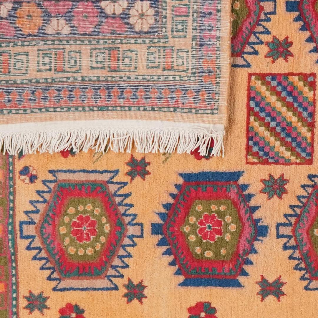 Antique Samarkand rug from China with a beige field and geometric medallions