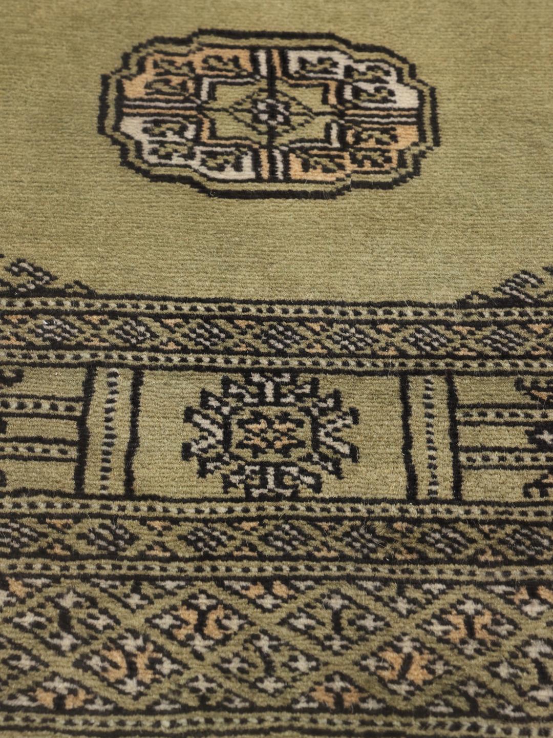 Hand-knotted Pakistani runner rug in light green with geometric patterns