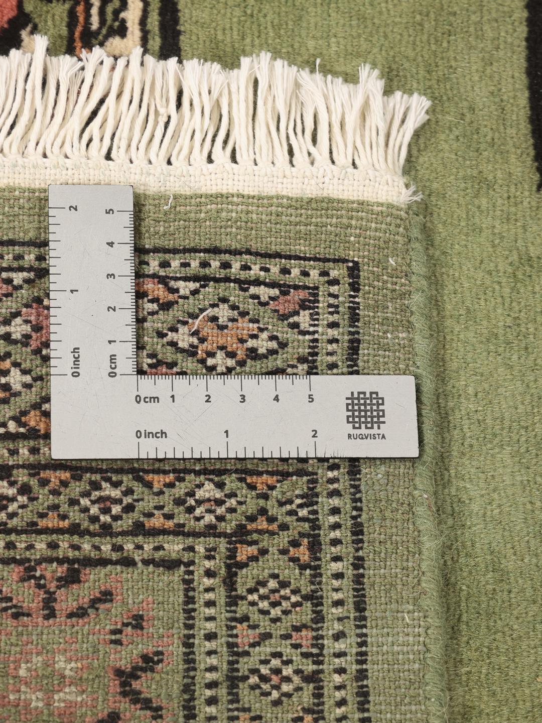 Hand-knotted Pakistani runner rug in light green with geometric patterns