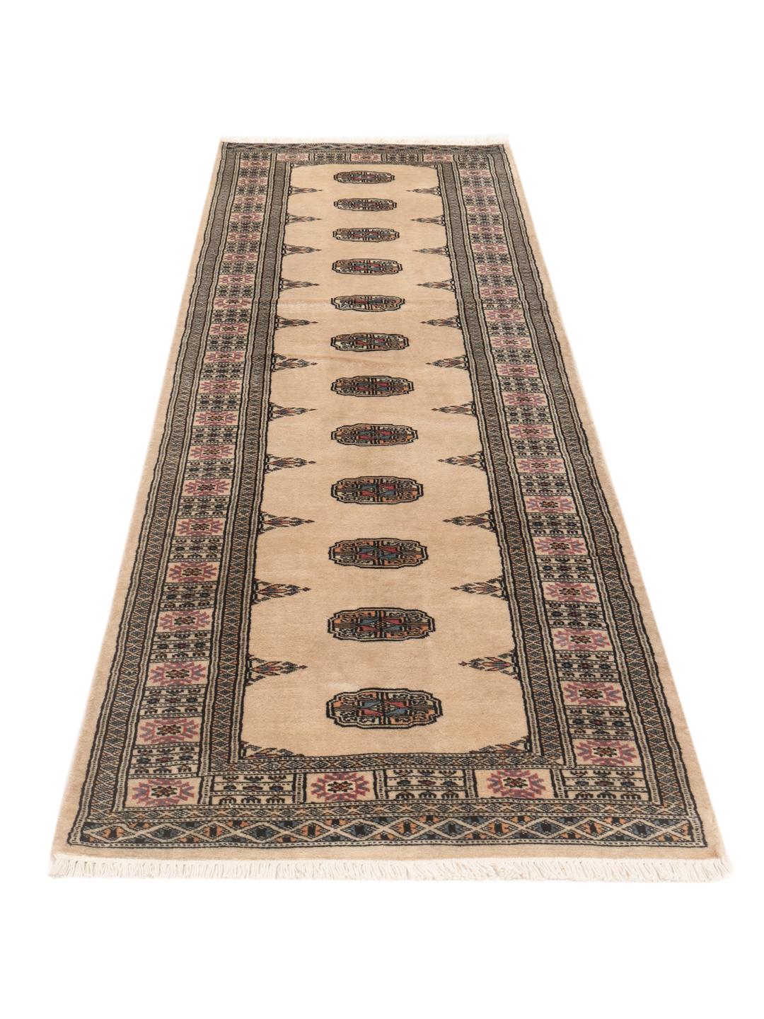 Hand-knotted beige runner rug from Pakistan with a traditional repeating medallion pattern
