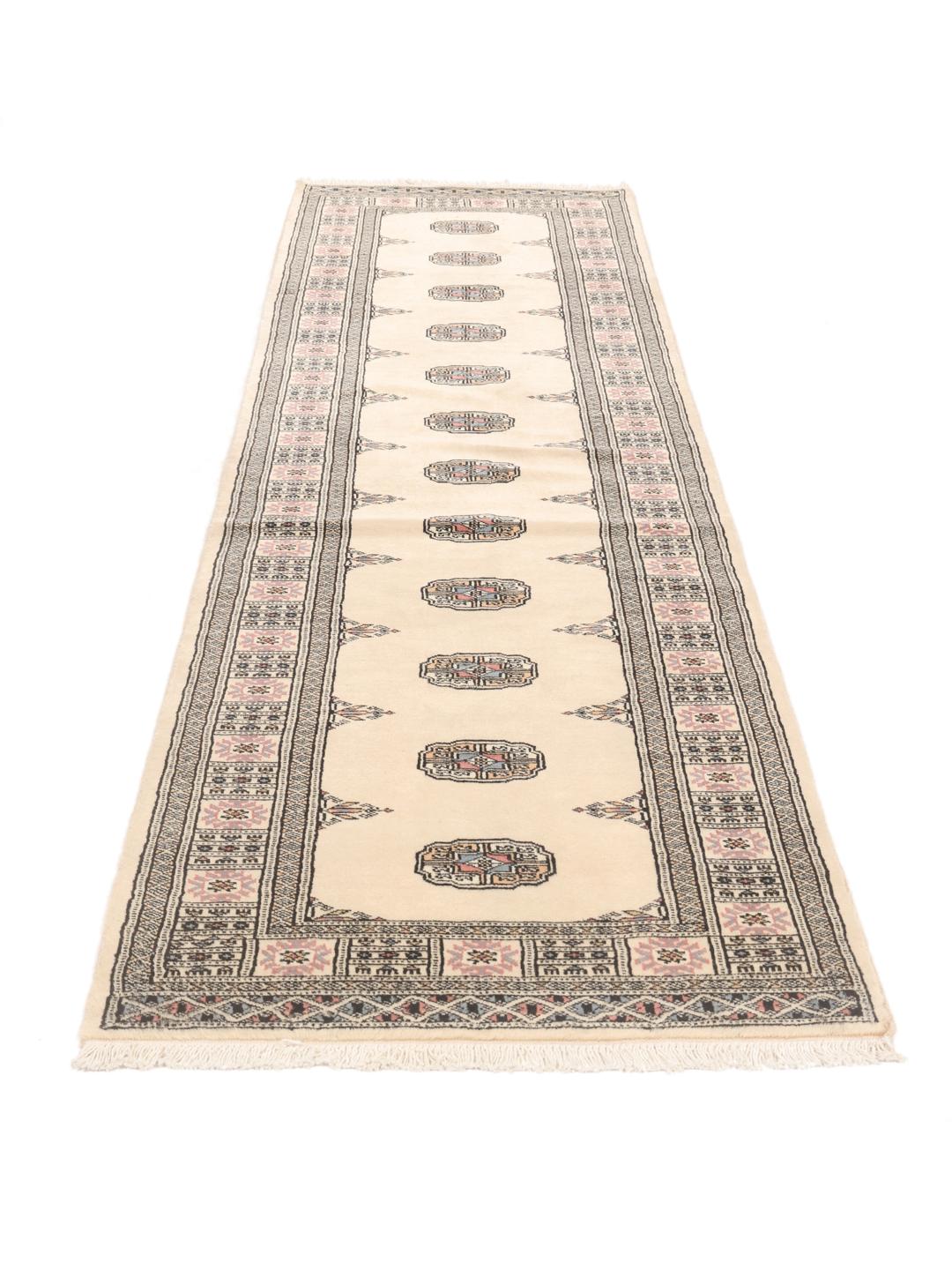 Hand-knotted beige runner rug from Pakistan with a traditional repeating medallion pattern