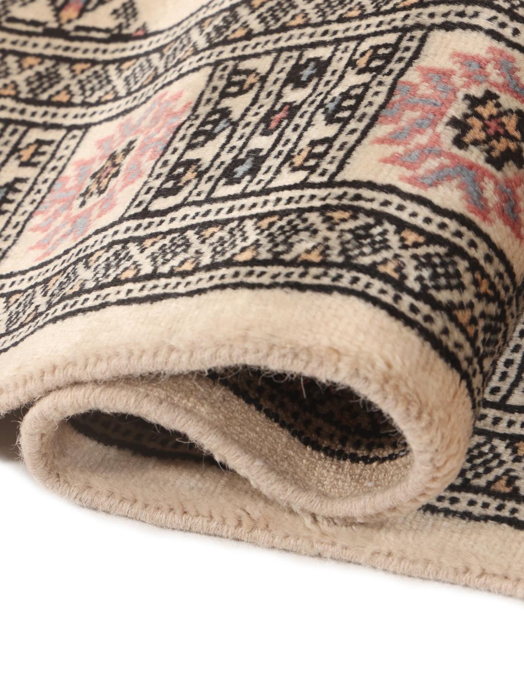 Hand-knotted beige runner rug from Pakistan with a traditional repeating medallion pattern