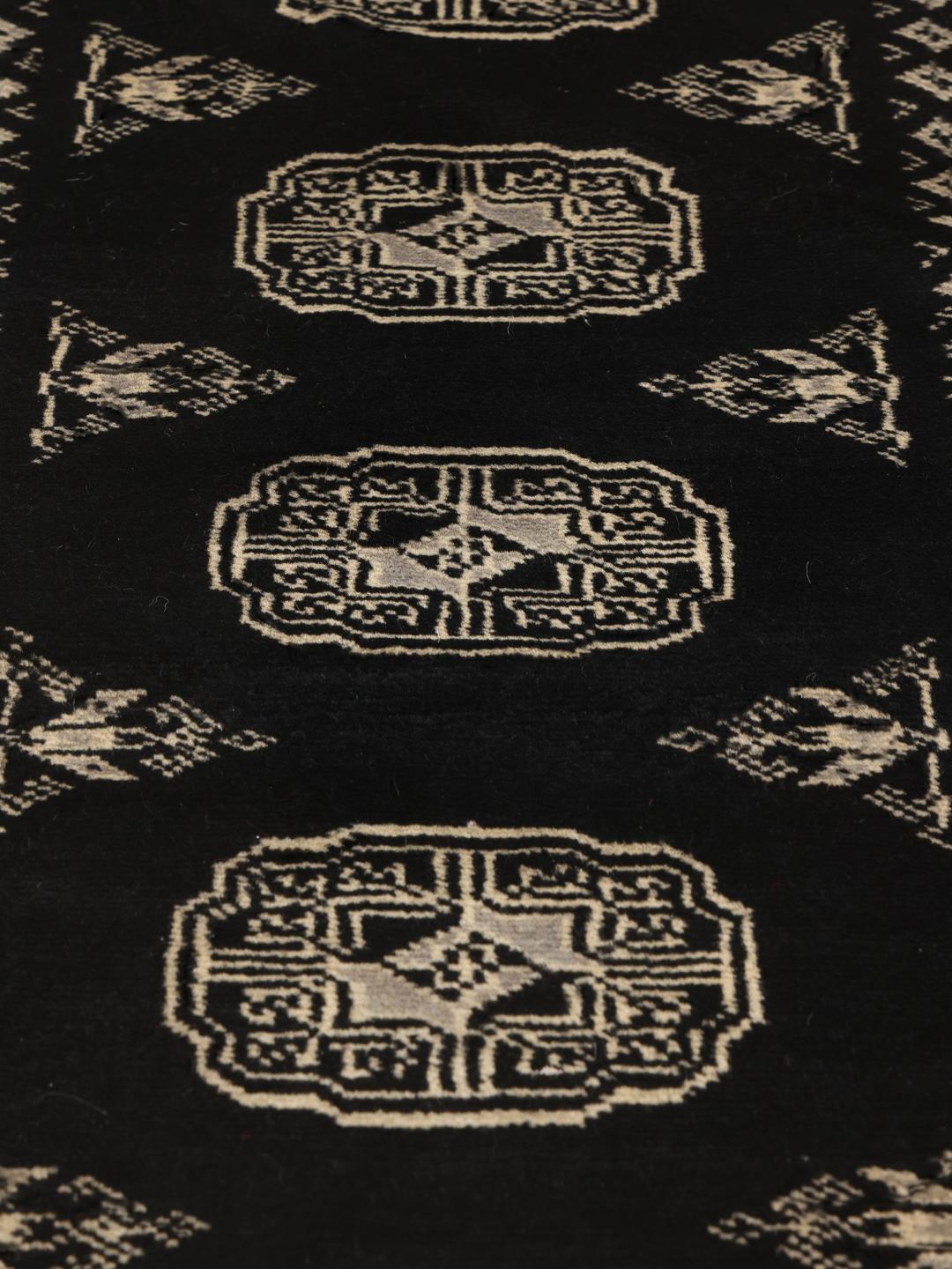 Hand-knotted Pakistan Bokhara runner in black with traditional geometric patterns