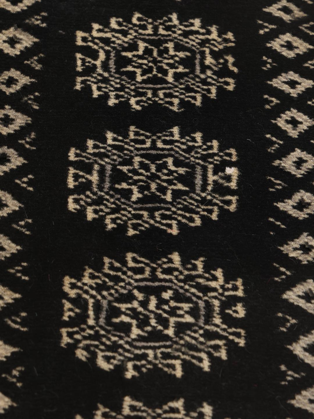 Hand-knotted Pakistan Bokhara runner in black with traditional geometric patterns