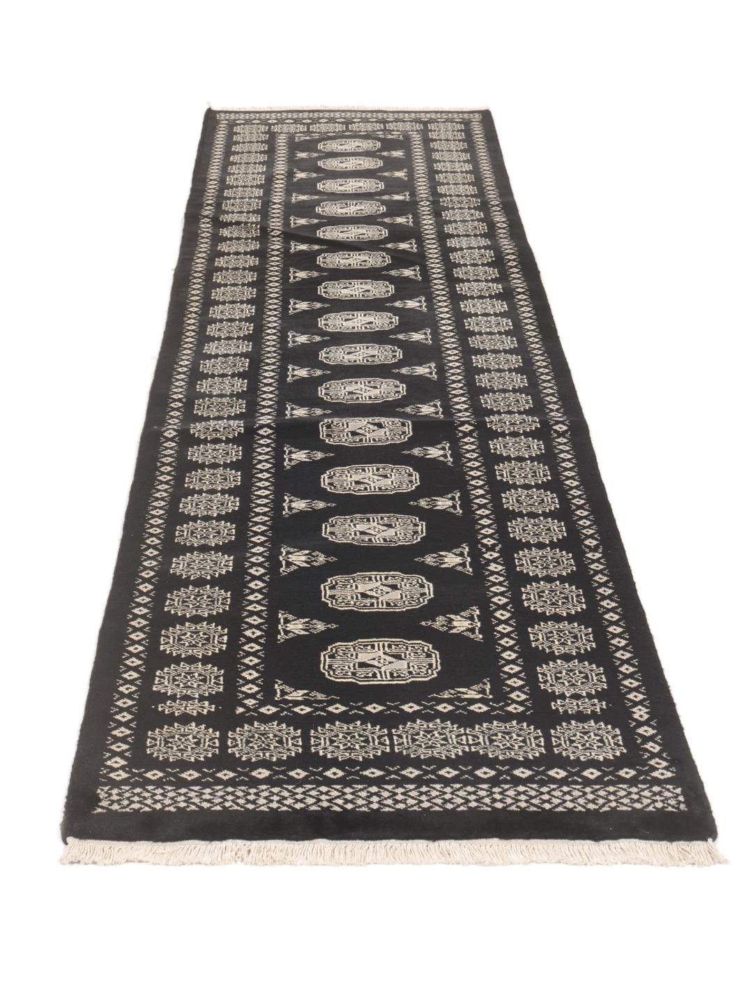 Hand-knotted Pakistan Bokhara runner in black with traditional geometric patterns