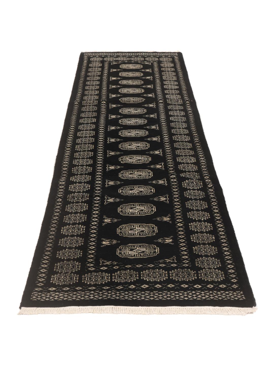 Hand-knotted Pakistan Bokhara runner in black with traditional geometric patterns